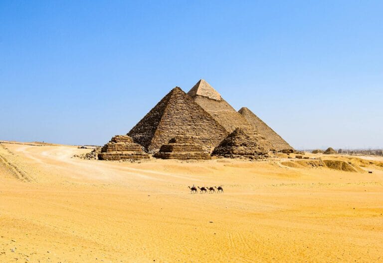 The iconic pyramids of Giza stand majestically in the vast desert of Egypt.